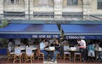 Customers sit at a cafe terrace in Lyon, central France, Wednesday, May, 19, 2021. It's a grand day for the French. Cafe and restaurant terraces are r