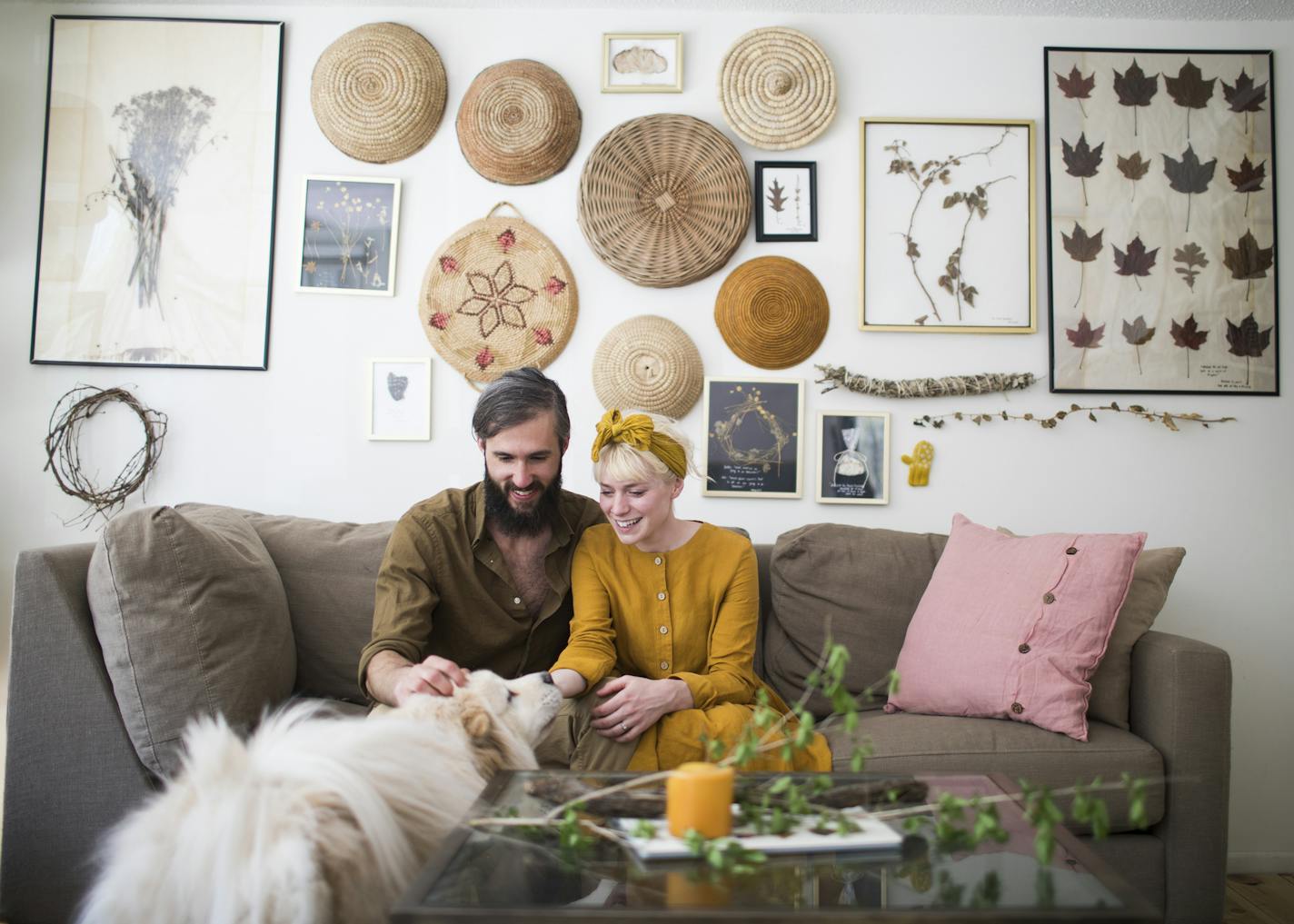 Max and Johnna Holmgren with their dog, Bruce, in their living room, which is decorated with finds from the forest.