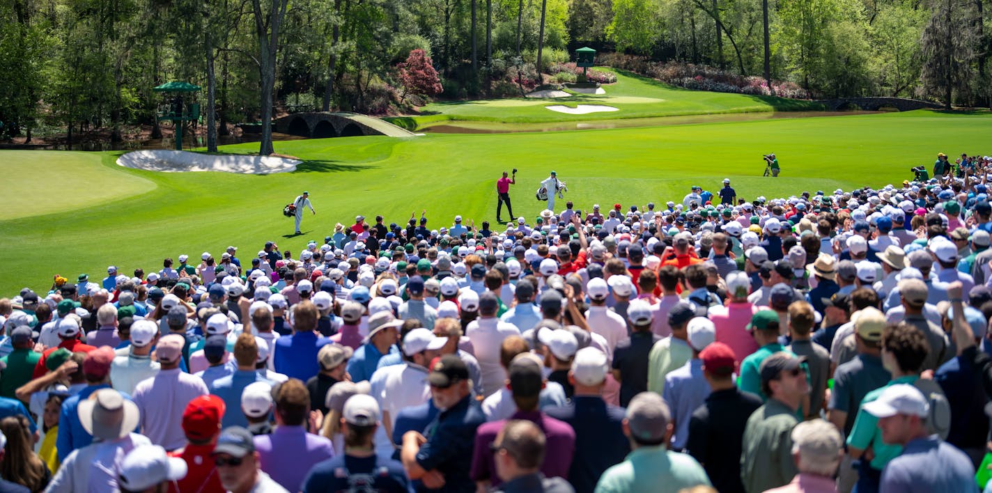 Tiger Woods tips his cap to the gallery after teeing off on No. 12 during first-round play at the Masters on Thursday.