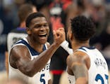 Anthony Edwards (5) congratulates Timberwolves teammate Monte Morris during Wednesday's victory over Toronto.