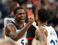 Anthony Edwards (5) congratulates Timberwolves teammate Monte Morris during Wednesday's victory over Toronto.