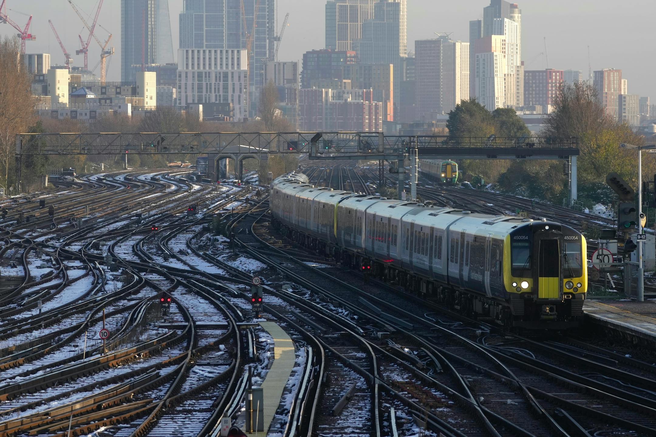 A train arrives a platform at Clapham Junction station in London, Wednesday, Dec. 14, 2022. Railroad workers across England walked off the job Tuesday, disrupting trains throughout the U.K. and starting what is expected to be a month of strikes by public service workers demanding higher pay as soaring inflation erodes living standards. (AP Photo/Kin Cheung)