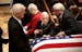 Harold Gifford leans in to touch the passing casket of his brother Quentin Gifford following a Celebration of Life service for the young sailor on the
