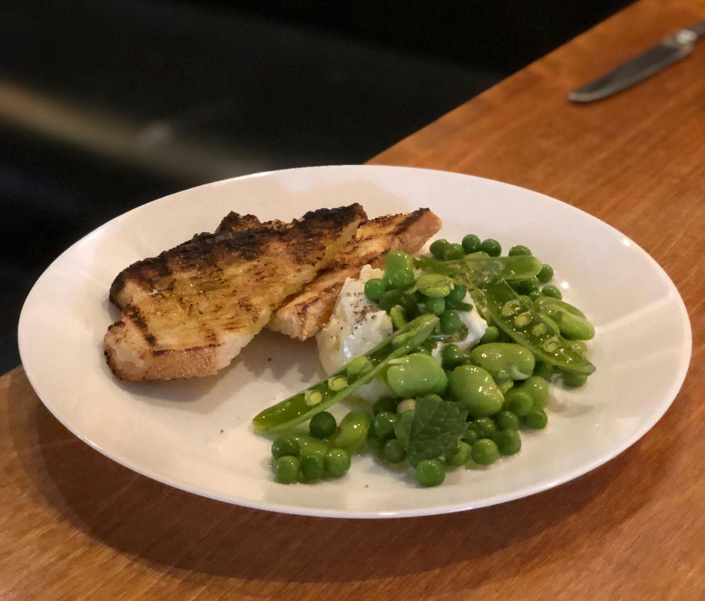 Mozzarella with fresh pea and fava bean salad is among the courses at Gia @ Cave Vin. Nicole Hvidsten, Star Tribune