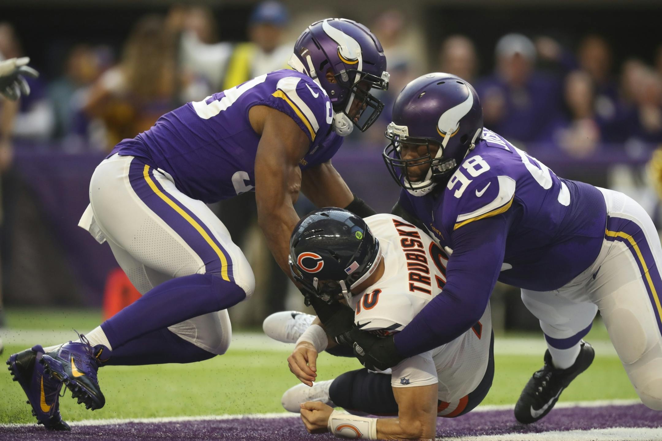 Vikings defensive tackle Linval Joseph (98) forced Chicago Bears quarterback Mitchell Trubisky (10) to get rid of the ball in the endzone, for a Vikings safety in the second quarter. Vikings defensive end Danielle Hunter (99) helped out at left.