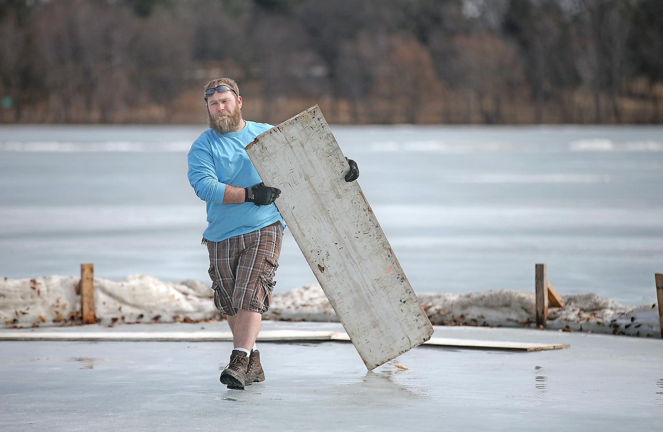 Kreg Nielsen, cq, of Minneapolis Parks and Recreation, wore shorts and shades as he removed an ice rink from Lake Nokomis, Monday, March 9, 2015 in Minneapolis, MN. ] (ELIZABETH FLORES/STAR TRIBUNE) ELIZABETH FLORES &#x2022; eflores@startribune.com