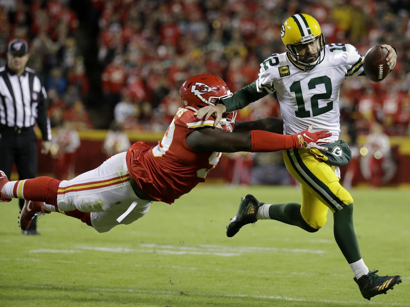 Green Bay Packers quarterback Aaron Rodgers (12) is tackled by Kansas City Chiefs defensive tackle Khalen Saunders (99) during the second half of an NFL football game against the Kansas City Chiefs in Kansas City, Mo., Sunday, Oct. 27, 2019. (AP Photo/Charlie Riedel)