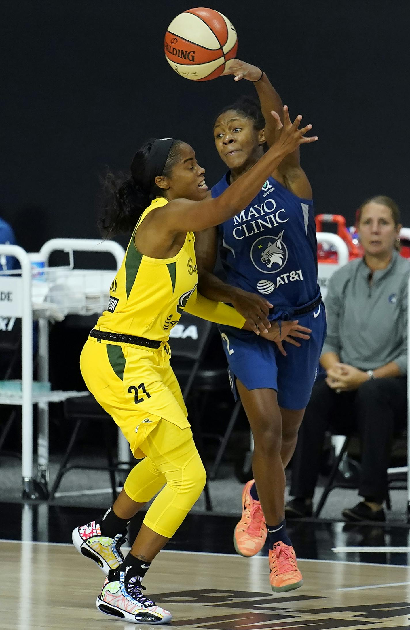 Minnesota Lynx guard Crystal Dangerfield (2) passes over Seattle Storm guard Jordin Canada (21) during the second half of Game 3 of a WNBA basketball semifinal round playoff series Sunday, Sept. 27, 2020, in Bradenton, Fla. (AP Photo/Chris O'Meara)