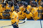 Quinnipiac forward Ethan de Jong (10) celebrates with the bench after his goal against Michigan.