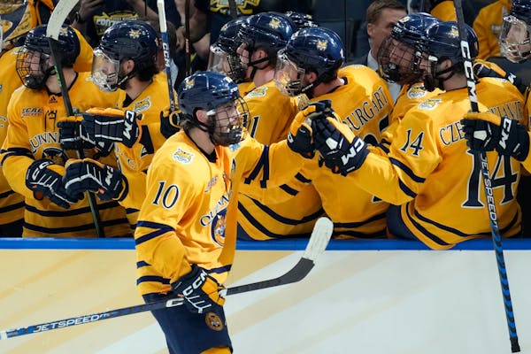 Quinnipiac forward Ethan de Jong (10) celebrates with the bench after his goal against Michigan.