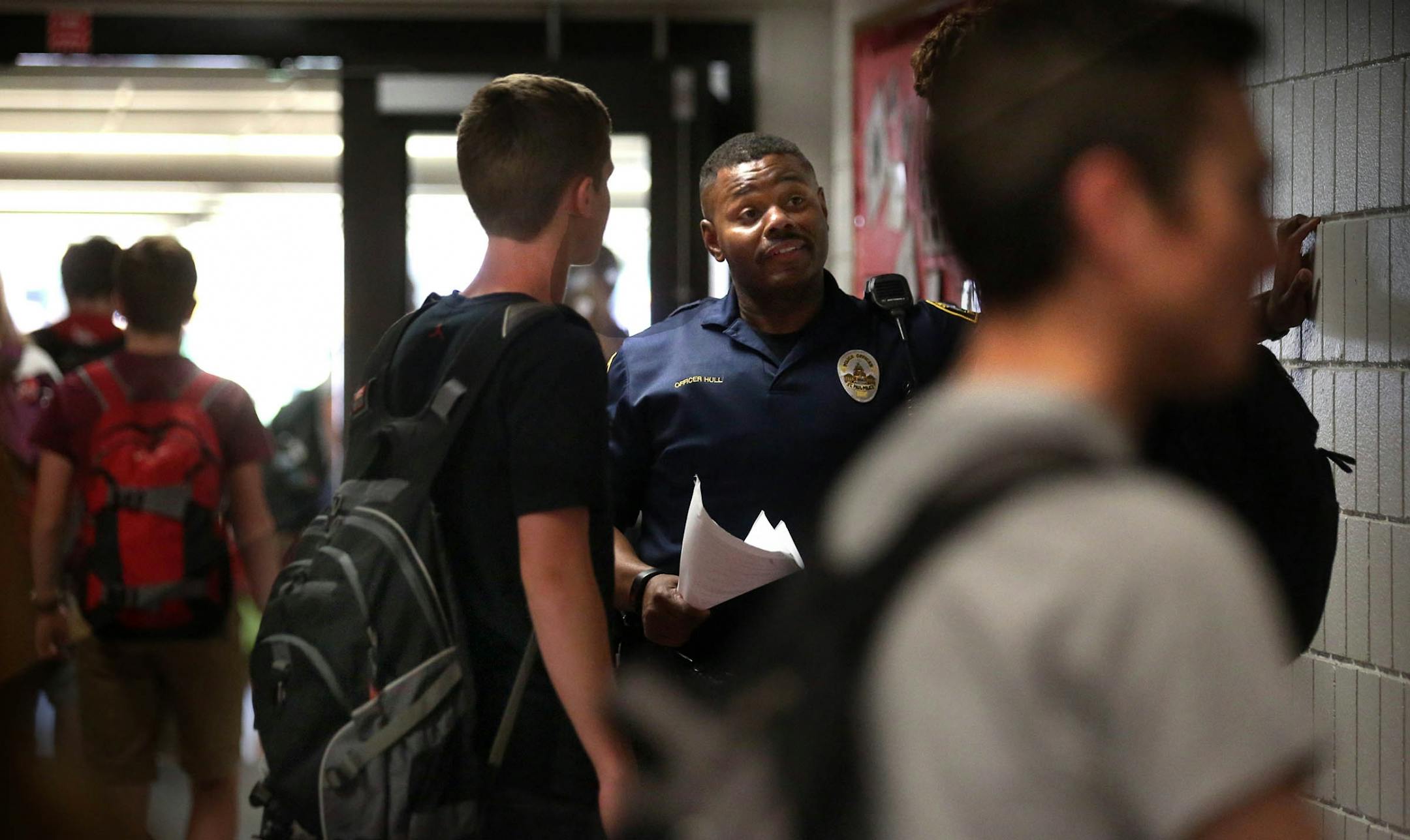 Cortez Hull, school resource officer (SRO) at Highland Park High School in St. Paul, interacted with students at the end of the school the day.