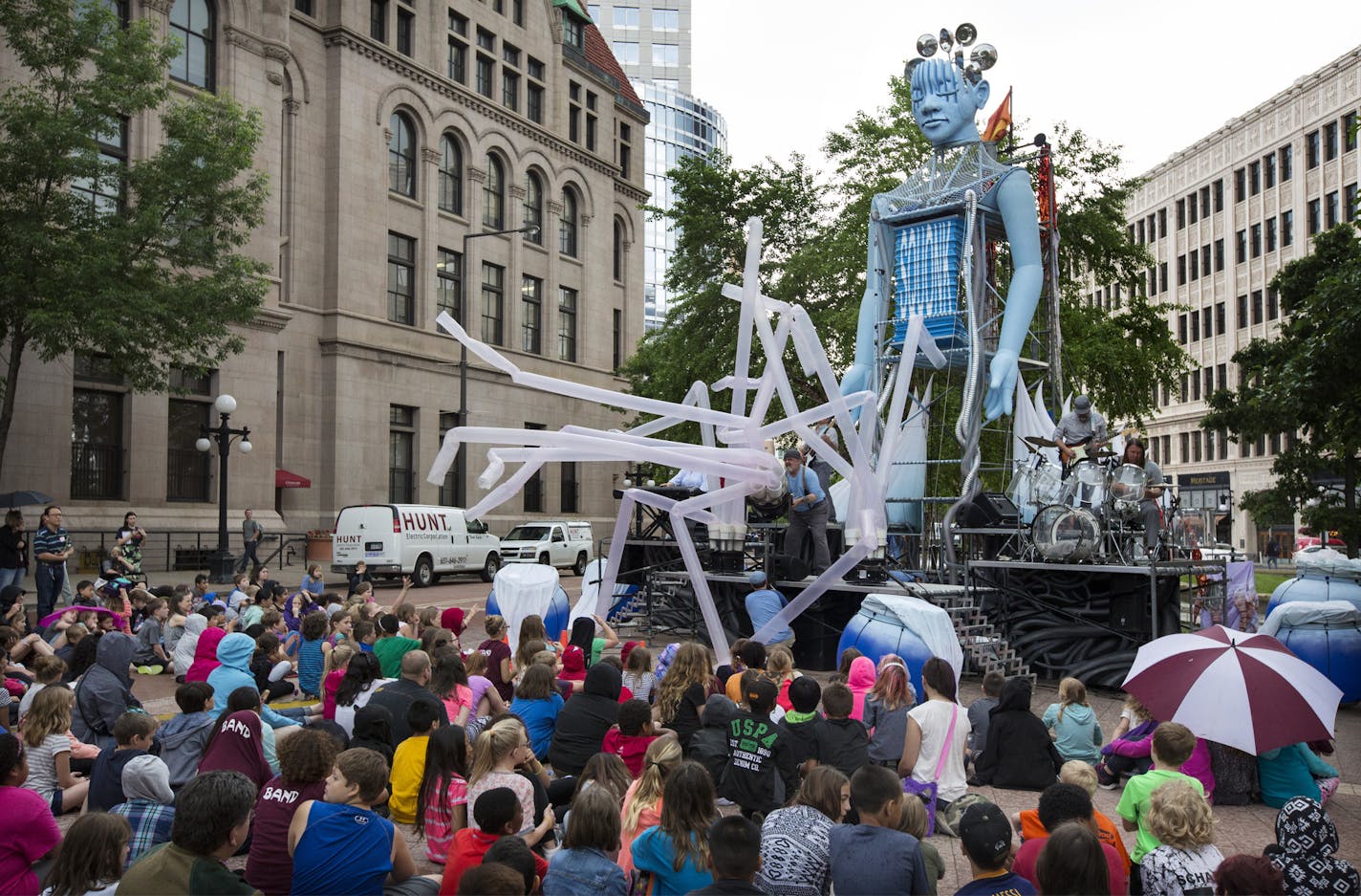 Students gathered at Wells Fargo Family Plaza in downtown St. Paul Tuesday got a sneak peek at Squonk Opera&#x2019;s Pneumatica, of one of the most highly anticipated acts of the 16th annual Flint Hills International Children&#x2019;s Festival. With live original music that permeates the air and inflatables that pump up and immerse the audience, the 40-foot-tall &#x201c;Lady Pneumatica&#x201d; is brought to life through music, imagery and the power of air.] St. Paul, MN - 05/25/2016