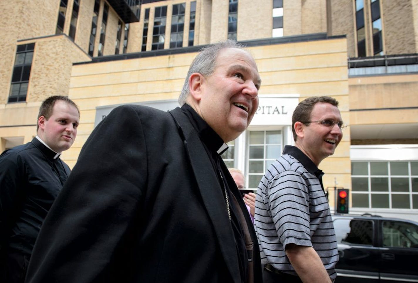 New interim Archbishop Bernard Hebda, center, walks with Deacon John Powers, left and Auxiliary Bishop Andrew Cozzens, right, out of St. John The Evangelist Catholic Church for a mass of priests only, Wednesday, June 17, 2015 in Rochester.