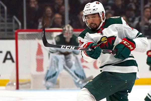 FILE - In this Saturday, March 7, 2020, file photo, Minnesota Wild defenseman Matt Dumba passes the puck during the first period of an NHL hockey game