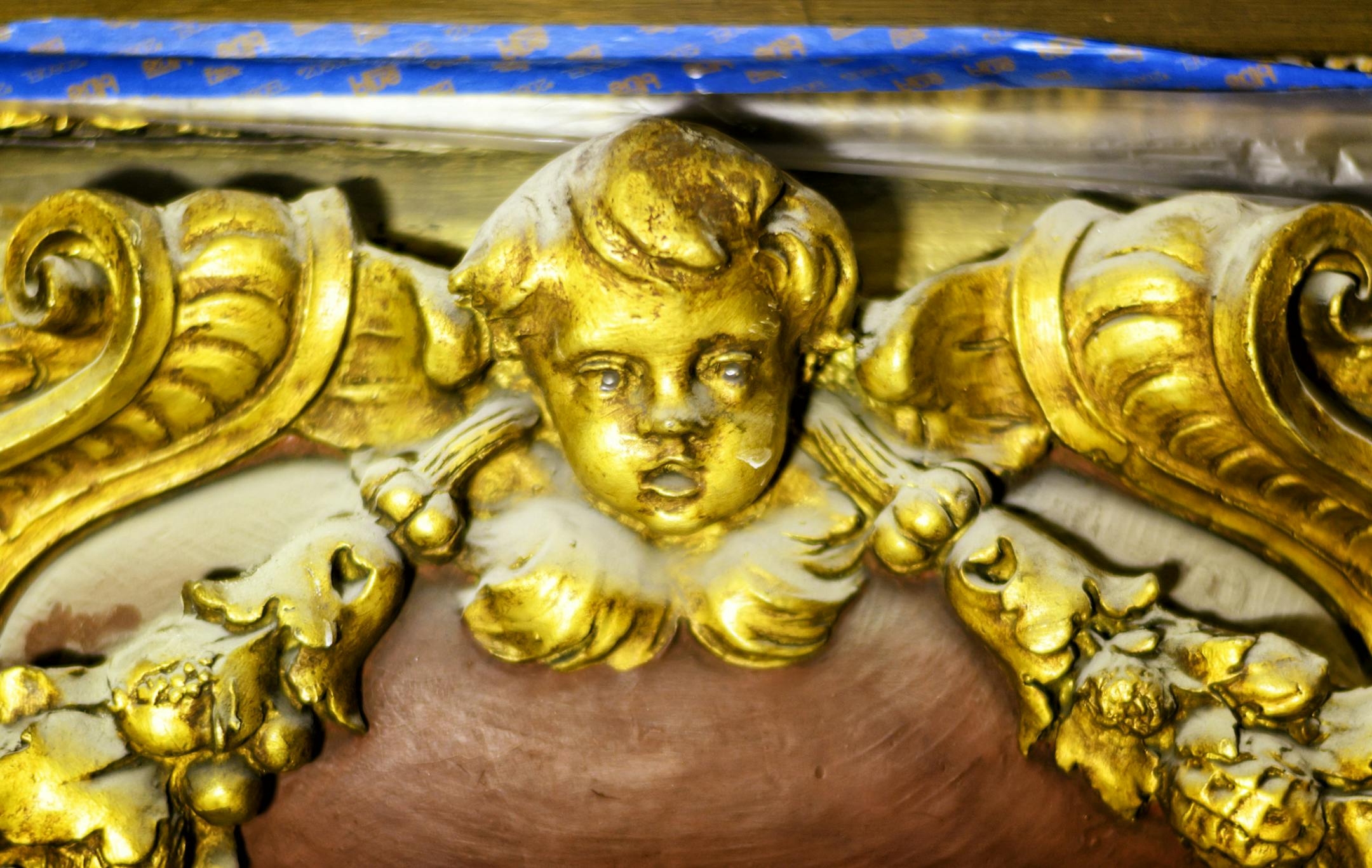 A golden cherub gathered dust on the ceiling of the Governor's Reception Room.