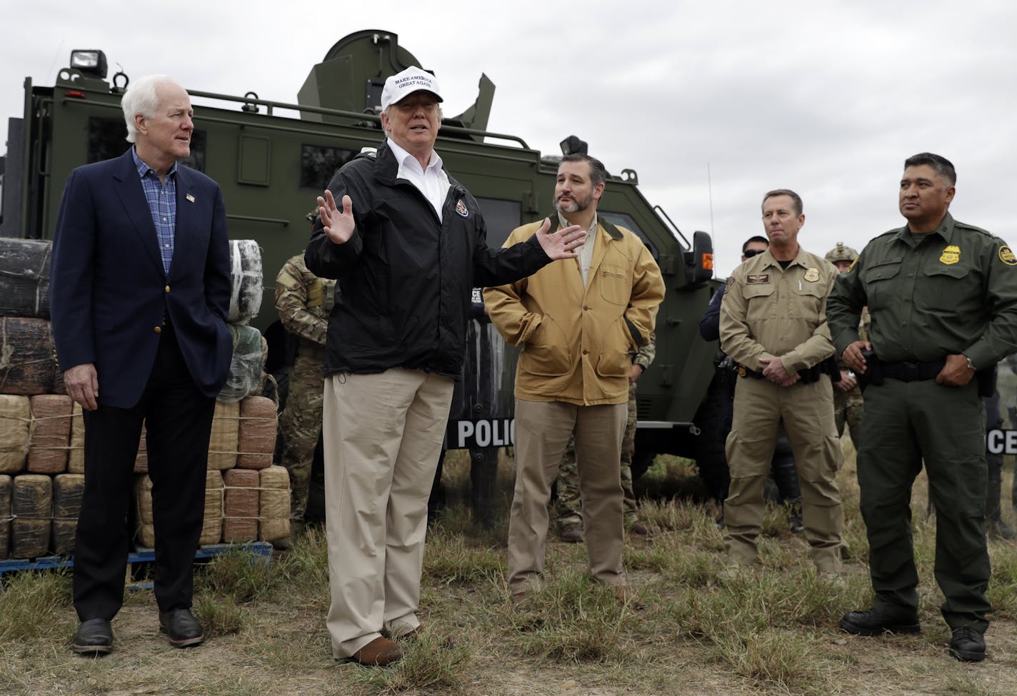 President Donald Trump speaks as tours the U.S. border with Mexico at the Rio Grande on the southern border, Thursday, Jan. 10, 2019, in McAllen, Texas, as Sen. John Cornyn, R-Texas, left, and Sen. Ted Cruz, R-Texas, listen. (AP Photo/ Evan Vucci)