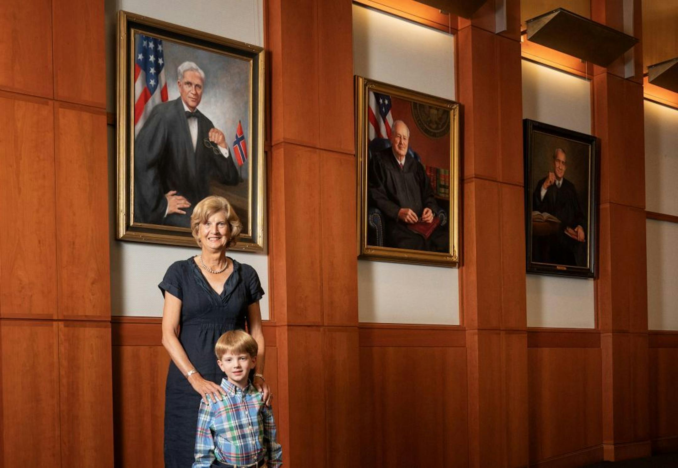 Grandaughter of Gunnar Nordbye Andrea Bassett and and great-great grandson of Gunnar Nordbye Gunnar Bassett with the judge's newly hung portrait in the Chief Judges chamber on the 15th floor of the Minneapolis federal courthouse. Nordbye's portrait now hang in the courtroom where Chief Judge John Tunheim presides.