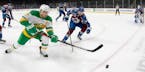 Zach Parise (11) of the Minnesota Wild and Samuel Girard (49) of Colorado Avalanche chased the puck in the first period.