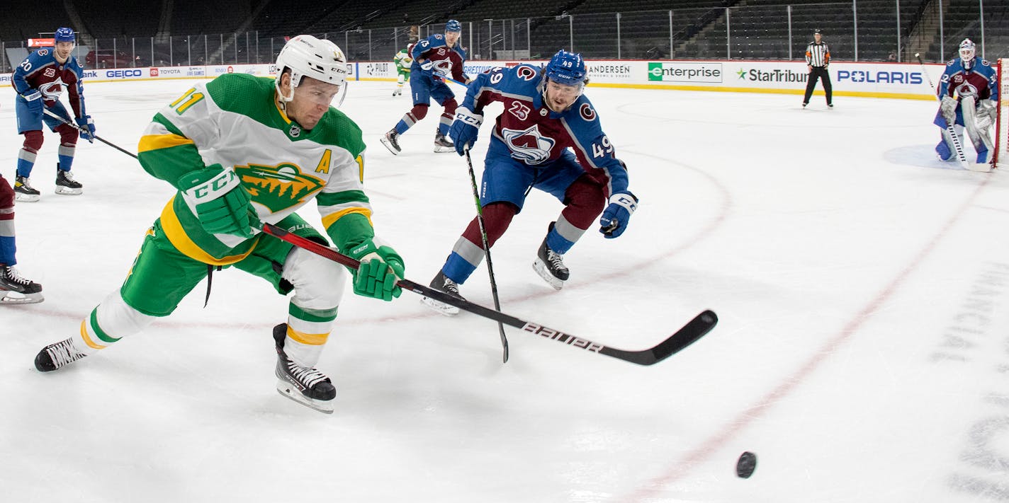 Zach Parise (11) of the Minnesota Wild and Samuel Girard (49) of Colorado Avalanche chased the puck in the first period.