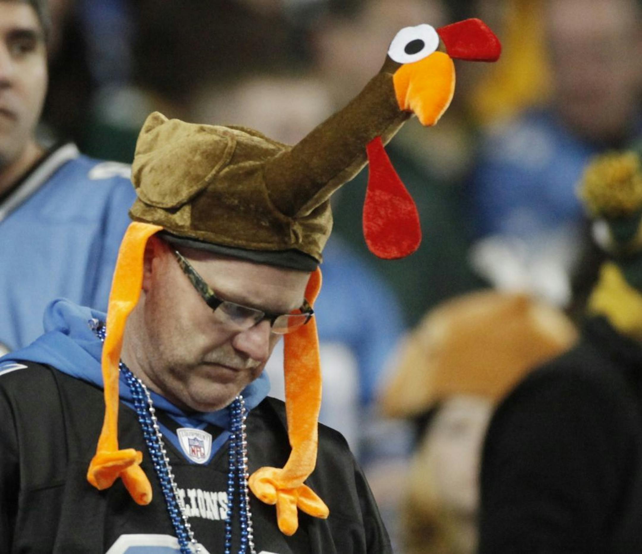 A fan gets into the spirit with a turkey head covering on Thanksgiving Day.