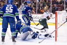 Wild left winger Jordan Greenway celebrated his score-tying goal against Canucks goaltender Jacob Markstrom (25) during the first period Monday night 