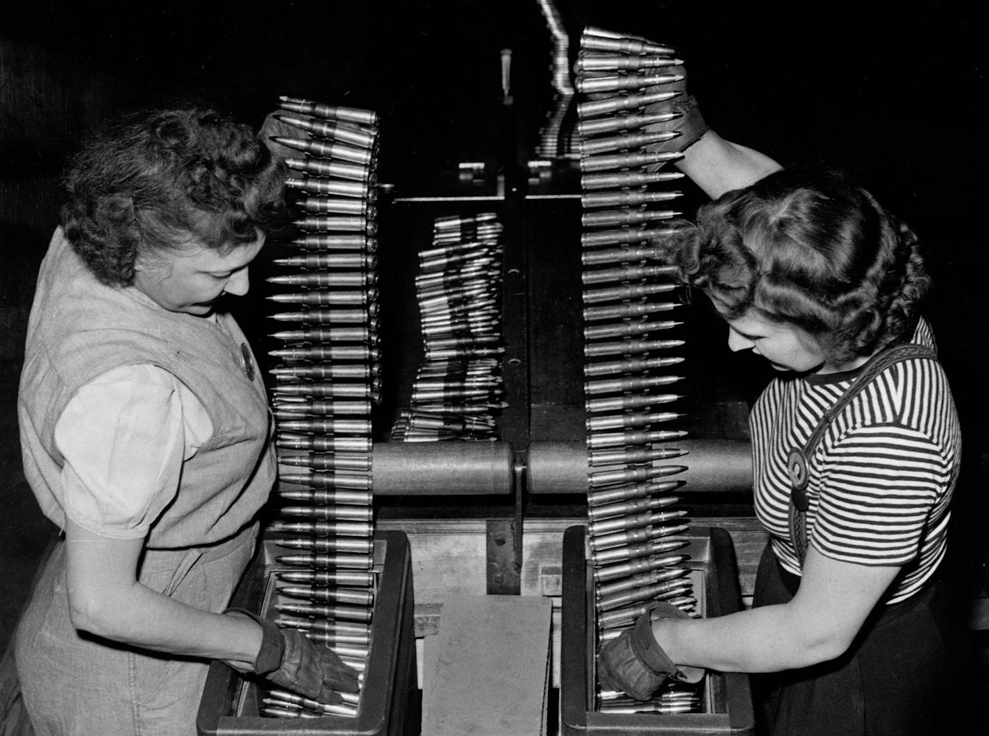 Twin Cities Ordnance Plant workers packing cartridge belts made at the arms factory in the 1940s.