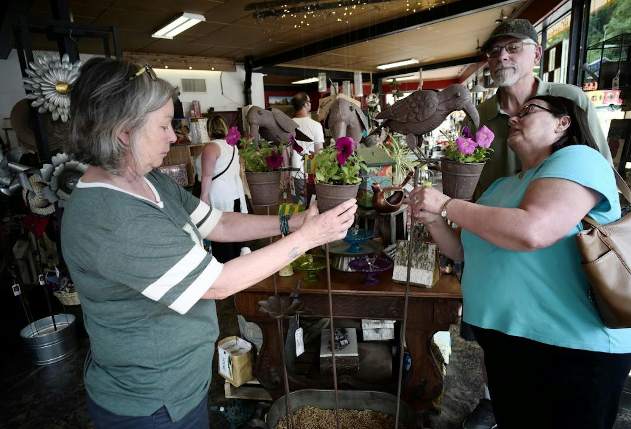Sales associate Peggy Pribil helped Steve and Beckie LeRoy with a unique planter.
