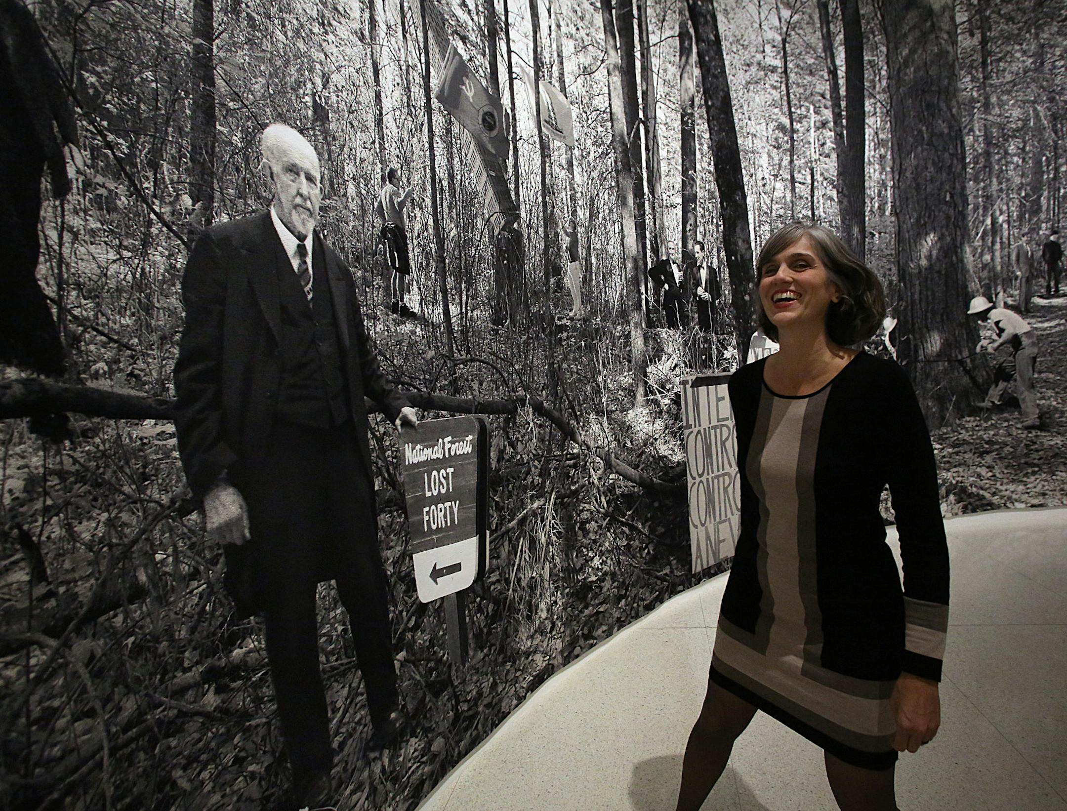 Walker director Olga Viso struck a pose with the center's founder, lumber baron T.B. Walker, as depicted in "Lost Forty," a 2011 tapestry by Goshka Macuga. Photo by JIM GEHRZ, jgehrz@startribune.com