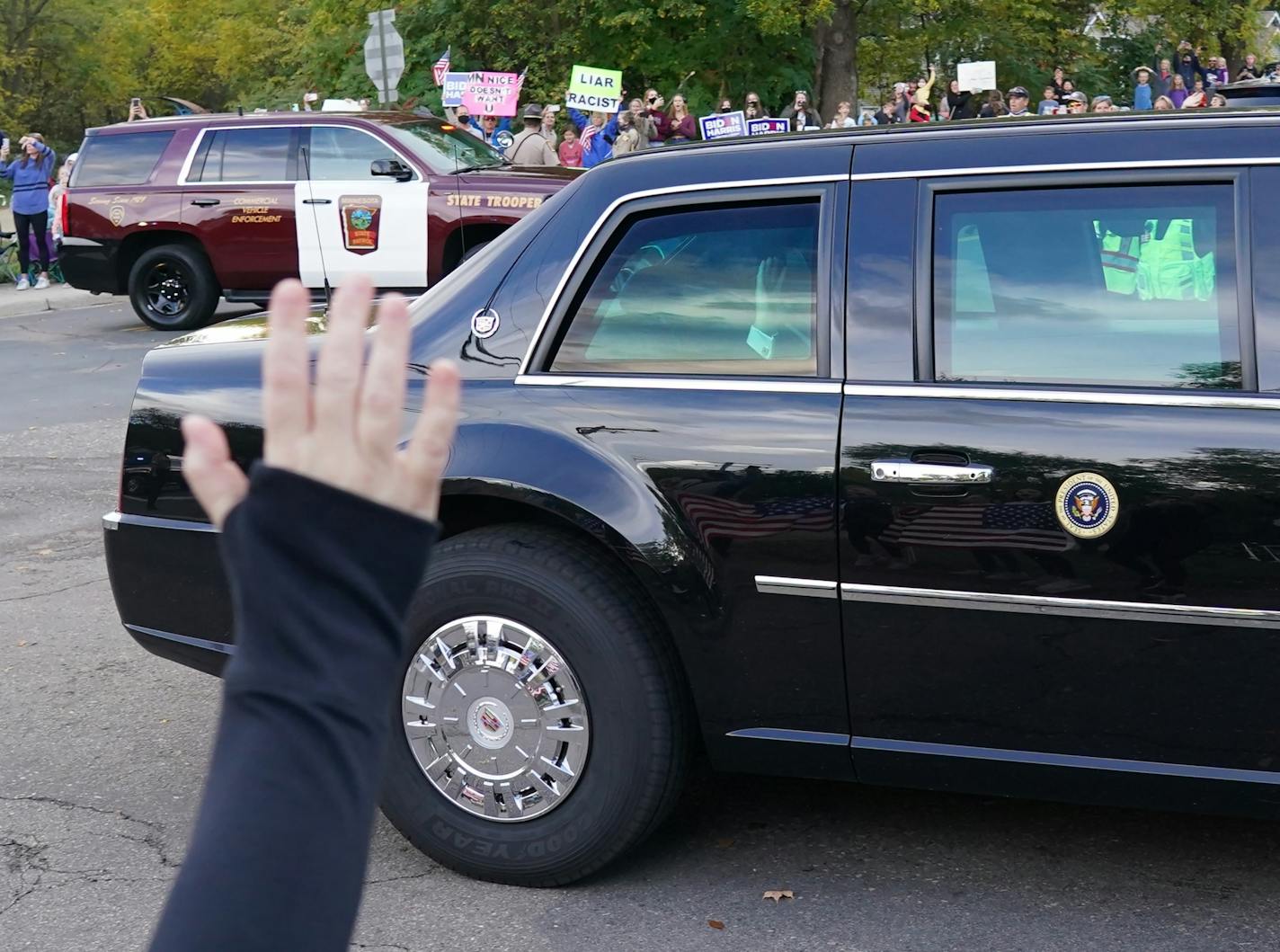 President Trump arrived to supporters and opponents as the motorcade sped through Shorewood, Minn. near the home of Marty Davis, where Trump held a private fundraiser on Wednesday, Sept. 30, 2020.