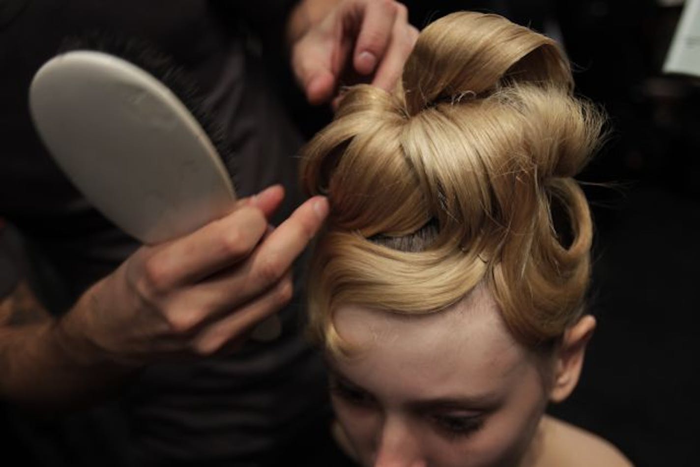 Models get their hair and make-up done backstage before the Fall 2011 Monique Lhuillier show during Fashion Week in New York, Monday, Feb. 14, 2011.