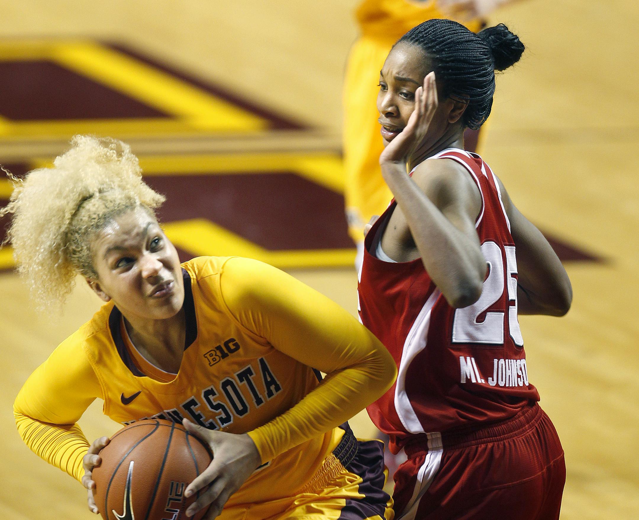 Minnesota's Micaella Riche dominated the boards under pressure by Wisconsin's Michala Johnson in the second half as the Minnesota Gophers took on the Wisconsin Badger at Williams Arena, Thursday, January 23, 2014 in Minneapolis, MN. The Gophers defeated Wisconsin 64 to 53.(ELIZABETH FLORES/STAR TRIBUNE) ELIZABETH FLORES • eflores@startribune.com