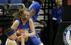 Players from Hopkins, left, and St. Michael-Albertville battled in the girls' basketball state tournament. Those matchups will become more routine, wi