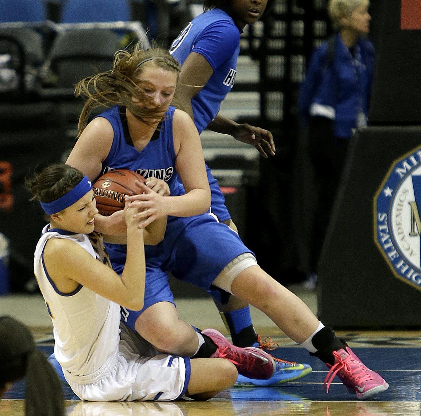 Players from Hopkins, left, and St. Michael-Albertville battled in the girls' basketball state tournament. Those matchups will become more routine, with St. Michael-Albertville (and Buffalo) joining the Lake Conference.