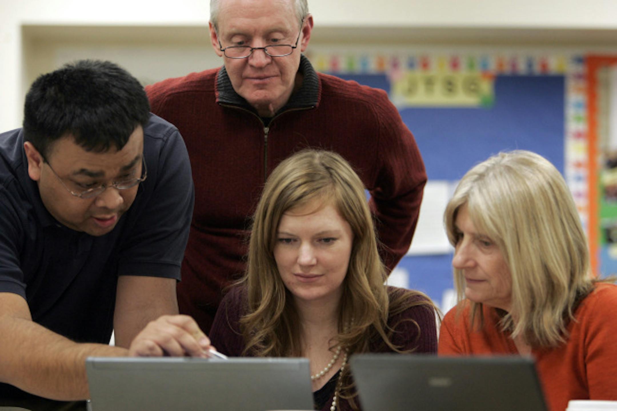 From left, Subilend Hem, Prof. Steve Ogren, Bonnie Sheridan and Marcia Kolb last week worked on a problem in Ogren's managerial finance course through Bethel University, held at Wooddale Church in Eden Prairie.
