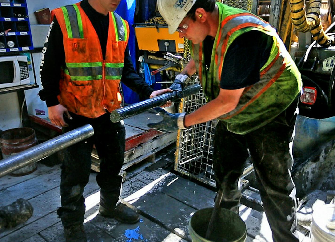 Drillers for Twin Metals, at a site near the Kiwishiwi River, pull a core sample from the drill pipe.