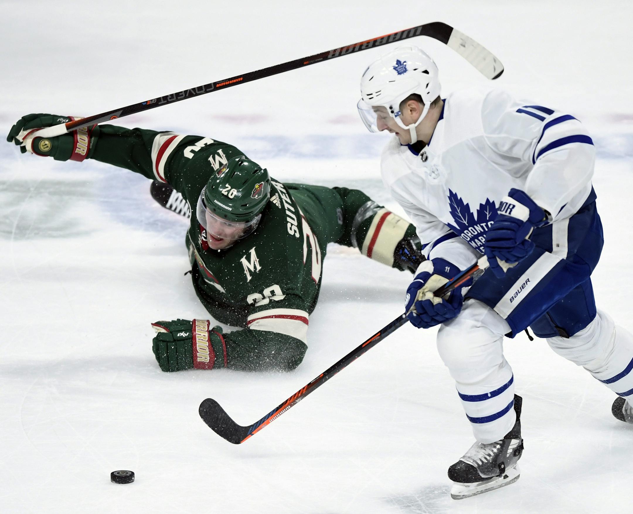 Minnesota Wild defenseman Ryan Suter (20) watches as Toronto Maple Leafs left wing Zach Hyman (11) takes the puck during the third period