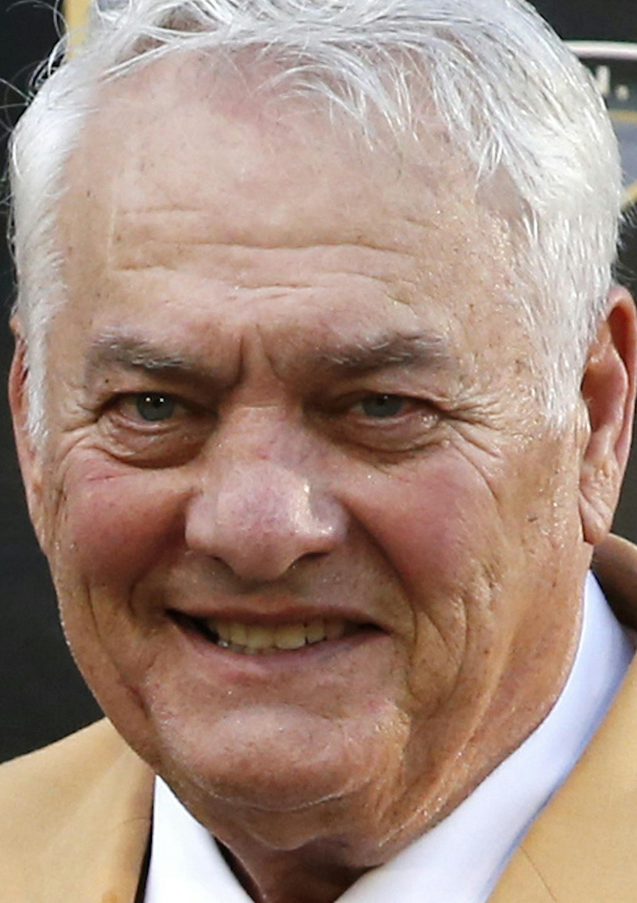 Former NFL player Mick Tingelhoff poses with his bust during inductions at the Pro Football Hall of Fame on Saturday, Aug. 8, 2015, in Canton, Ohio. (AP Photo/Gene J. Puskar)