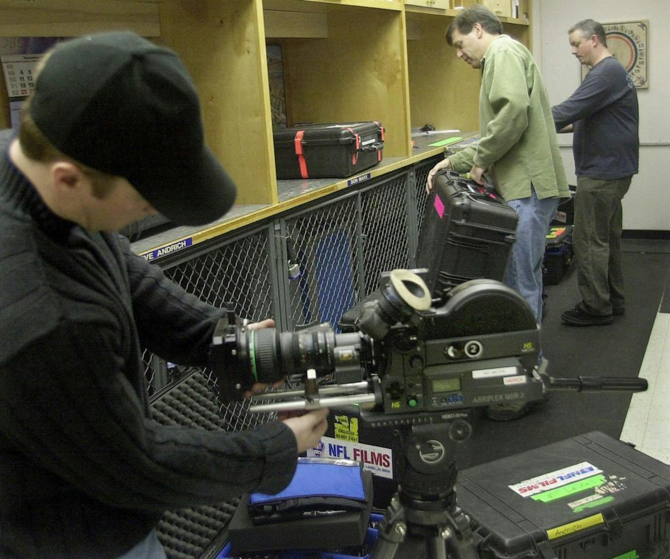 Steve Richer, center, vice president of cinematography at NFL Films, prepares camera equipment for Super Bowl XXXV at the company's facility in Mount Laurel, N.J.