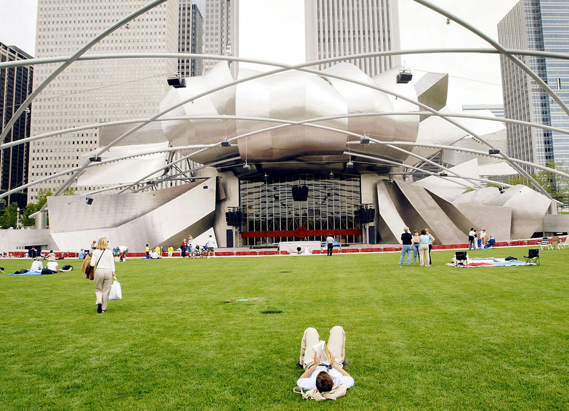 CHICAGO - JULY 16: Chicago residents and tourists explore the Pritzker Pavilion designed by famed architect Frank Gehry in the newly opened Millennium park July 16, 2004 in Chicago Illinois. The park which covers just over 24 acres cost nearly $500 million to build. (Photo by Scott Olson/Getty Images) ORG XMIT: MIN2014060612520259