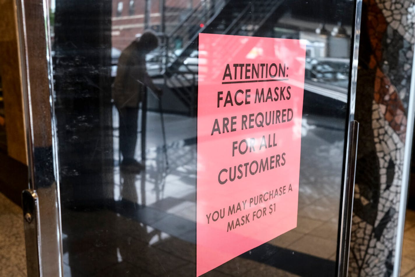 On Wednesday, Gov. Tim Walz announced a statewide mandate requiring Minnesotans to wear face masks in stores, public buildings and other places where people gather indoors. The new rules take effect Saturday. A sign outside Cafe Latte in St. Paul tells customers to wear masks inside.