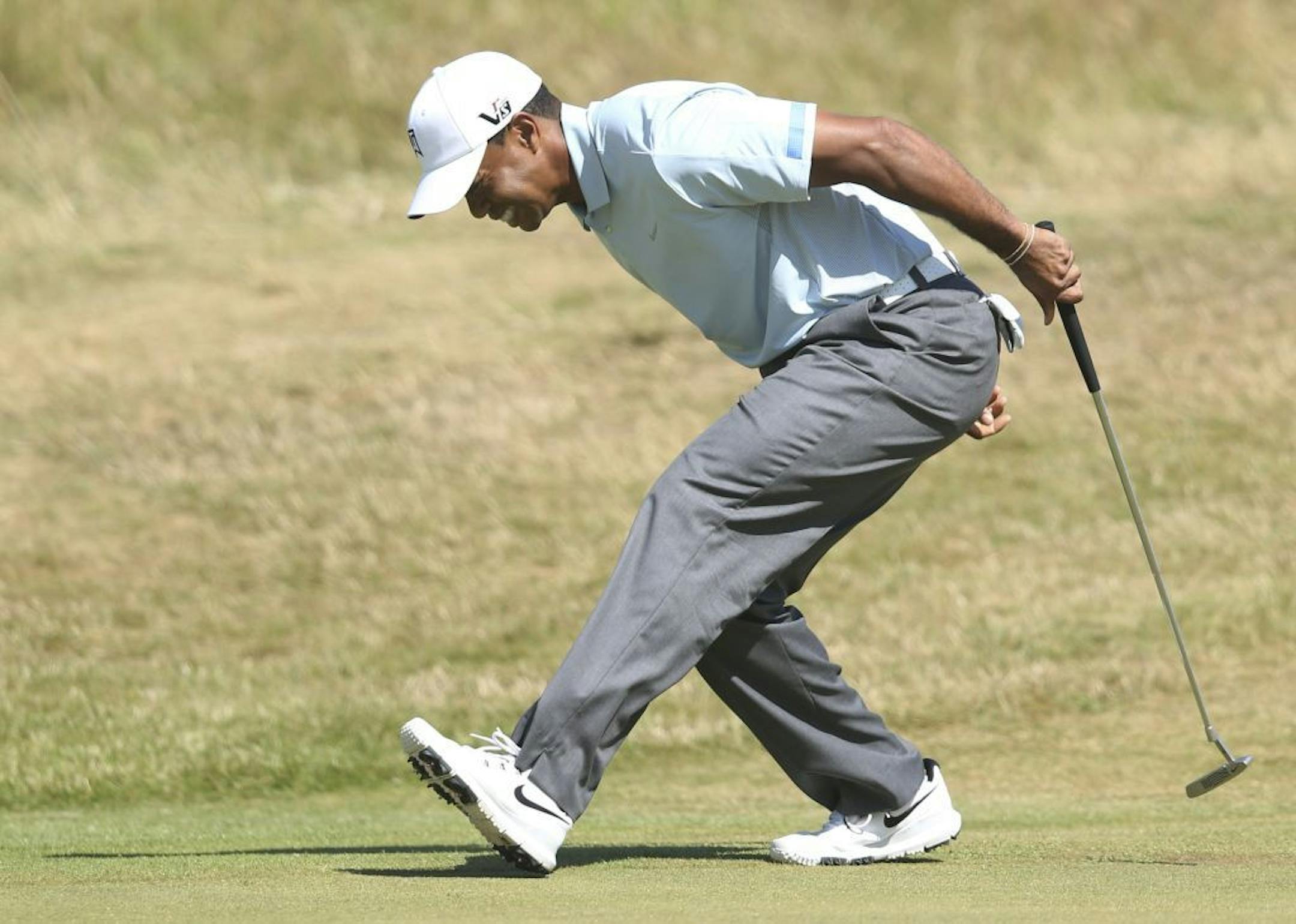 Tiger Woods of the United States reacts after putting on the 9th green during the second round of the British Open Golf Championship at Muirfield, Scotland, Friday July 19, 2013.