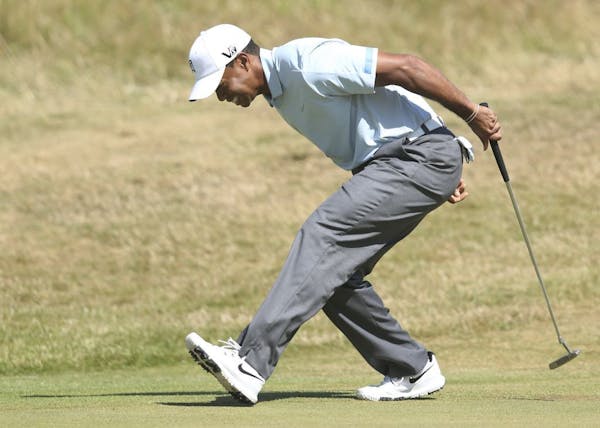 Tiger Woods of the United States reacts after putting on the 9th green during the second round of the British Open Golf Championship at Muirfield, Sco