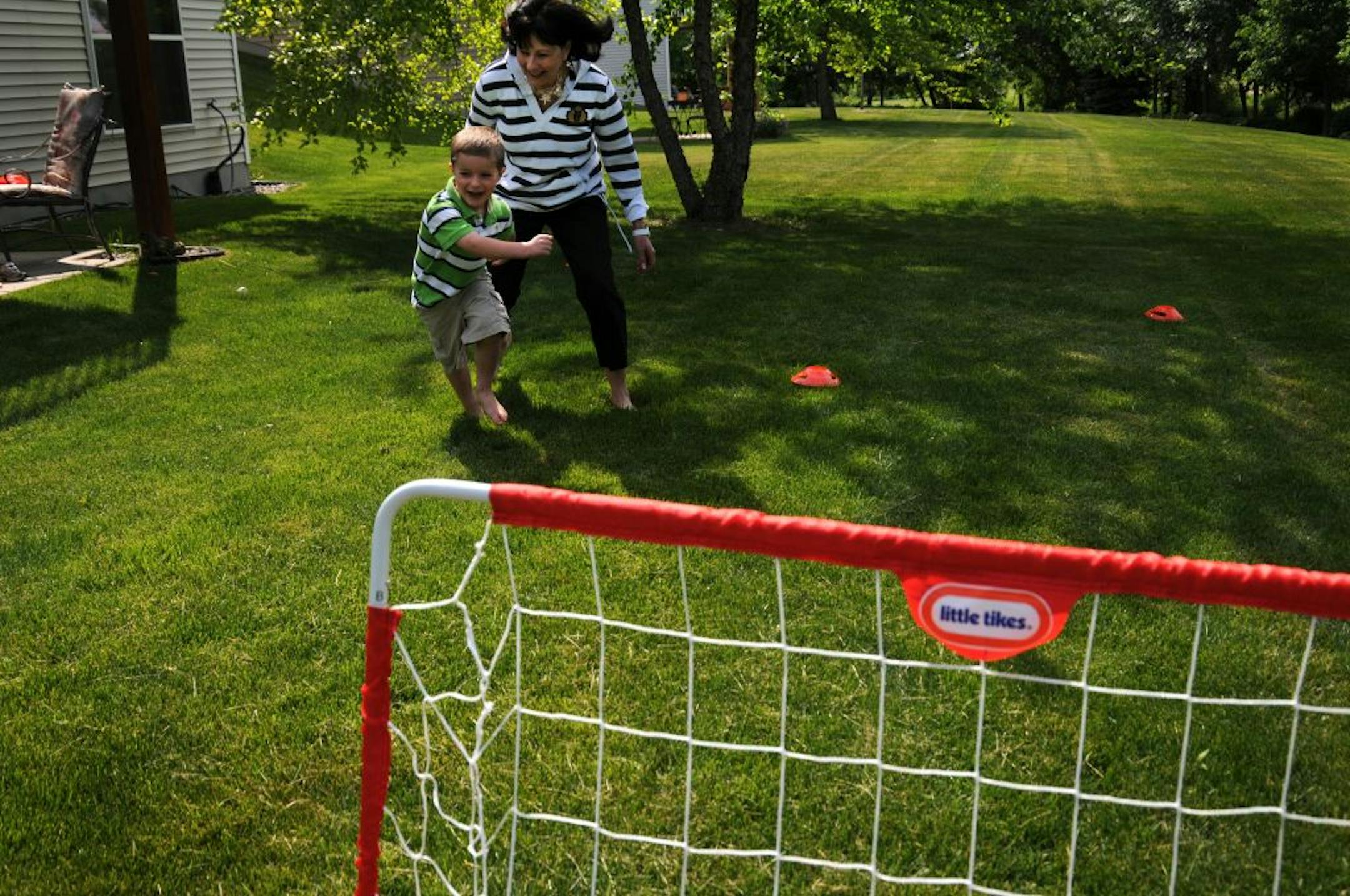 Harrison Watt, 3, was playfully chased by his grandmother, Mary Pat Myss, during a visit from Myss' daughter, Allison Watt and her two sons, at Myss' home in Pioneer Point. Myss' home is part of a Pulte development of single family homes that are association maintained, meaning things like maintaining the lawn and shoveling the snow are not her responsibility. "I would not own a single family home if I had to do the maintenance myself" said Myss, who works 40 hour weeks.