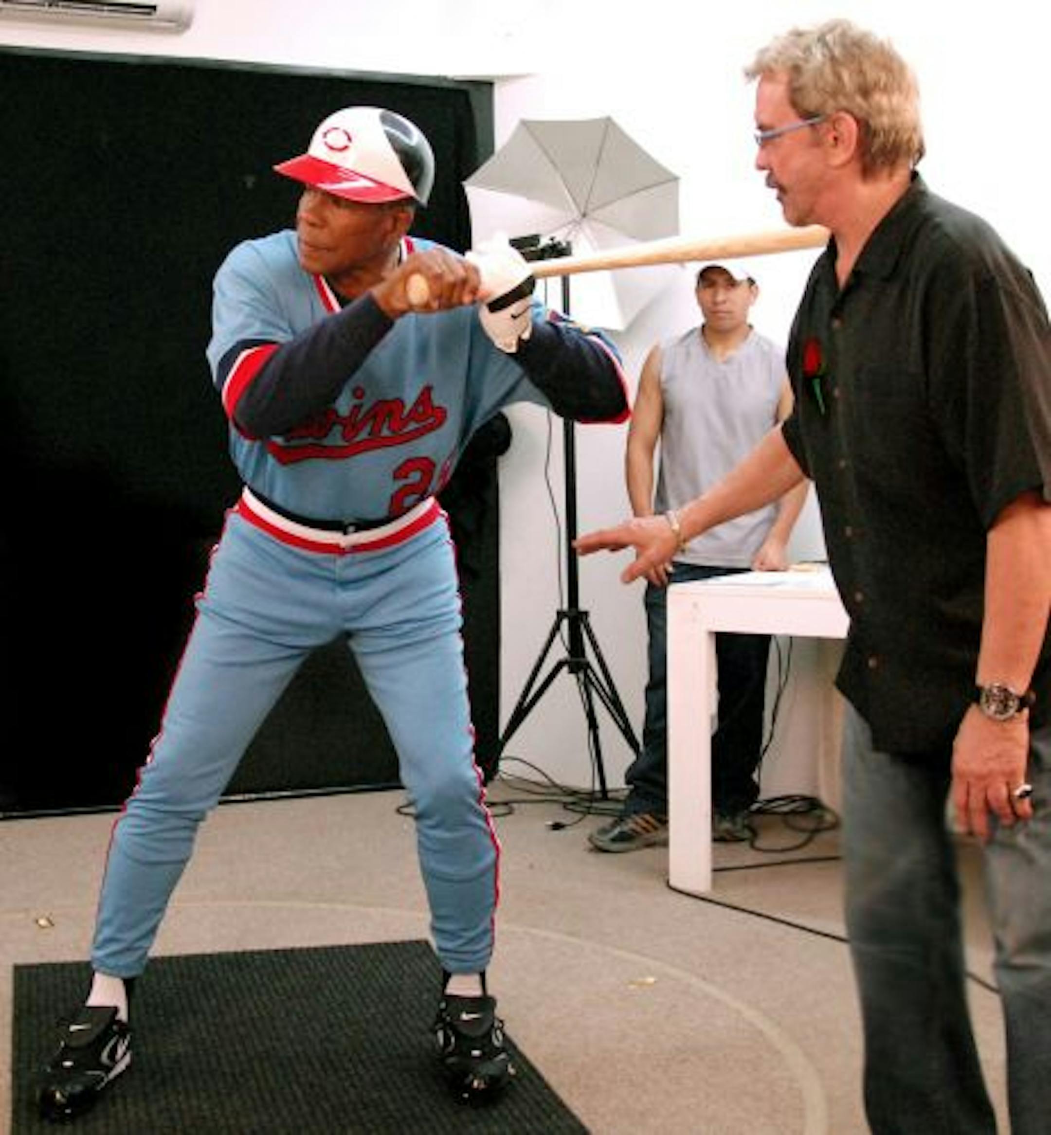 Rod Carew strikes his pose as Bill Mack watches.