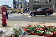 A memorial of flowers marks the area where Autumn Merrick was struck and killed in October 2021 during a rolling gun battle in downtown Minneapolis.