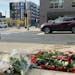 A memorial of flowers marks the area where Autumn Merrick was struck and killed in October 2021 during a rolling gun battle in downtown Minneapolis.