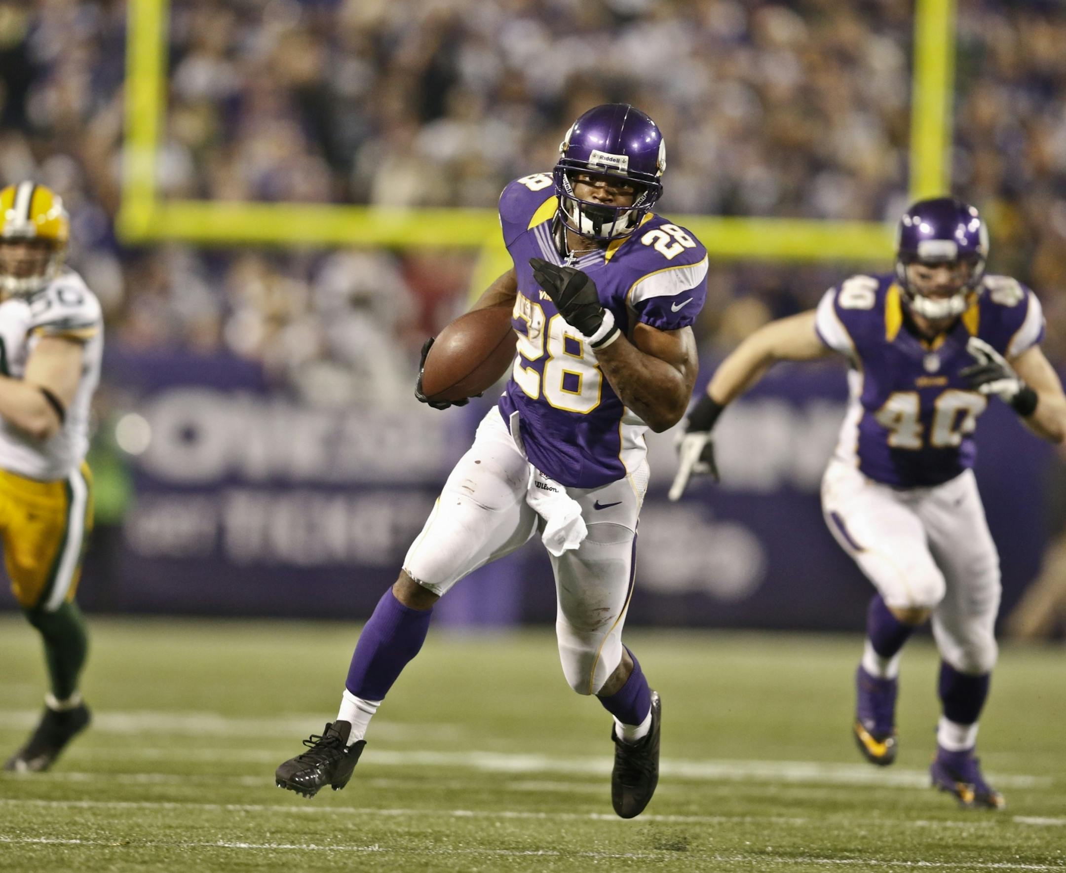 Vikings running back Adrian Peterson rushed in the third quarter against the Packers on Sunday, on his way to 199 yards in the game.