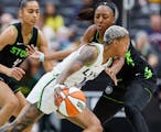 Lynx guard Courtney Williams drives against Storm forward Nneka Ogwumike during the fourth quarter of Tuesday night's WNBA opener in Seattle.
