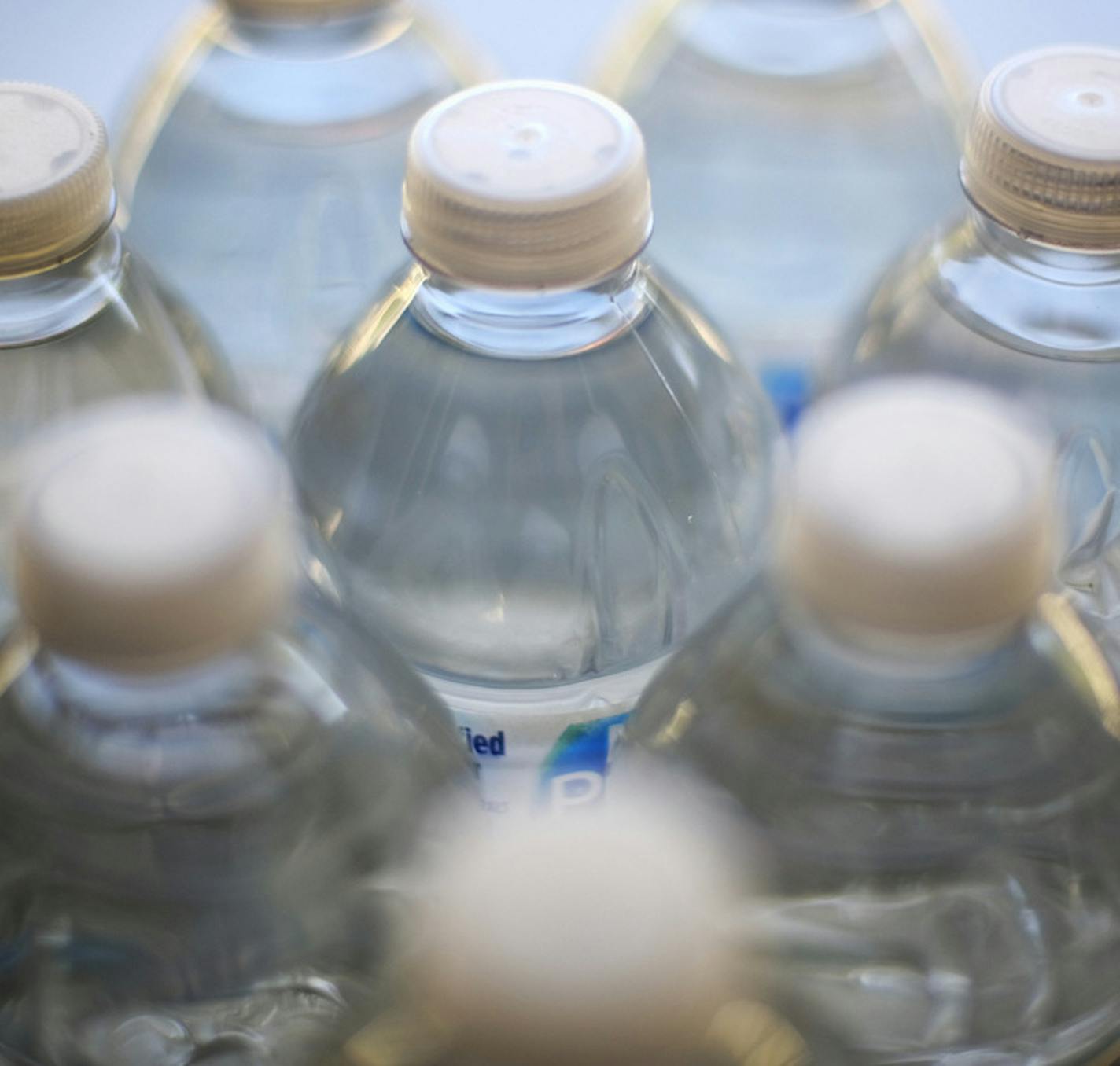 Drinking water is seen on a cafeteria table in Los Angeles on Friday, Aug. 2, 2109. In northern California, San Francisco International Airport is banning the sale of single-use plastic water bottles. The San Francisco Chronicle reports Friday that the unprecedented move at one of the major airports in the country will take effect Aug. 20, 2019. The new rule will apply to airport restaurants, cafes and vending machines. (AP Photo/Richard Vogel)