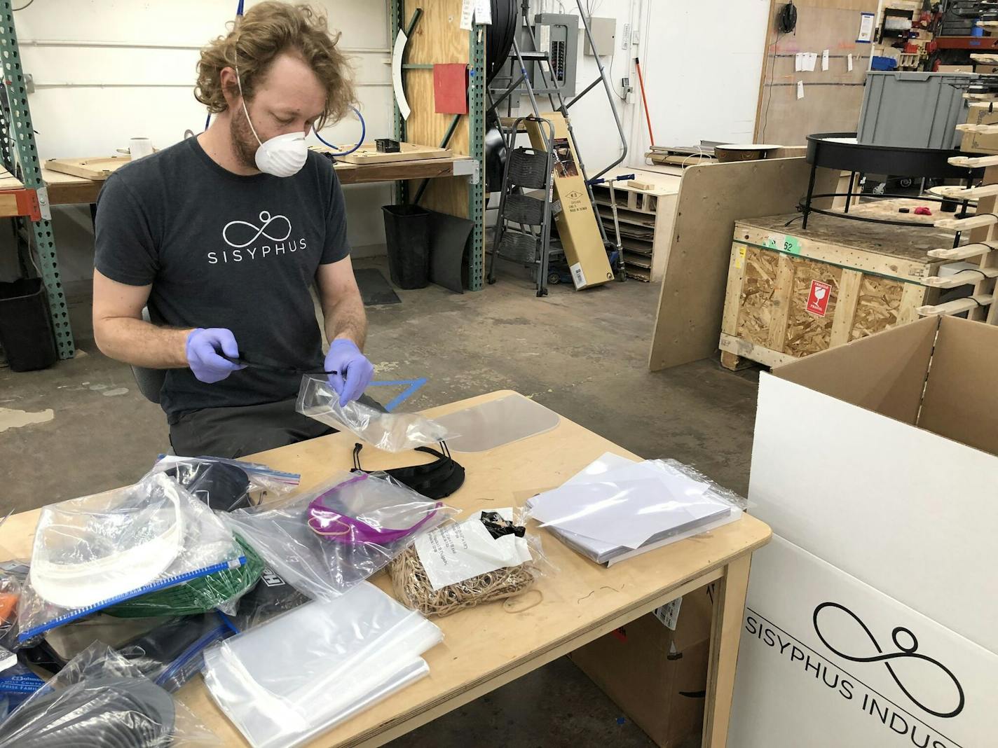 Micah Roth of Nordeast Makers assembles some of the thousands of protective face shields that Twin Cities volunteers are manufacturing on home 3D printers for donation to Minnesota hospitals, hospices and nursing homes. Photo credit: Tyler Cooper